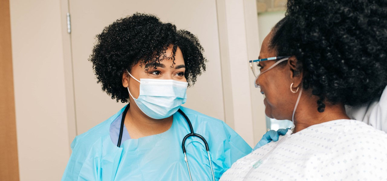 Caregiver talking to happy patient