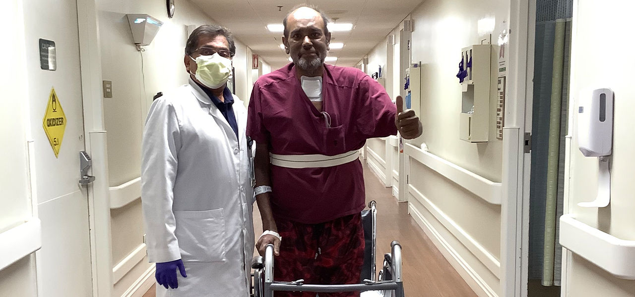 Happy patient leaving hospital with caregivers
