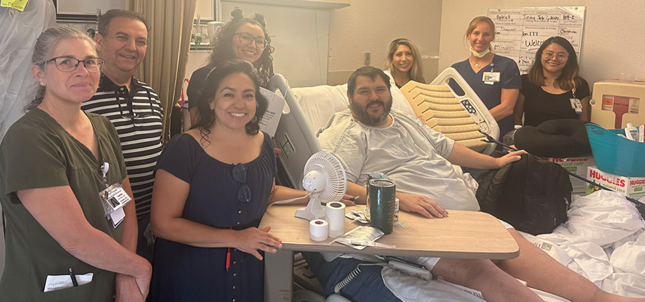 Happy patient leaving hospital with caregivers