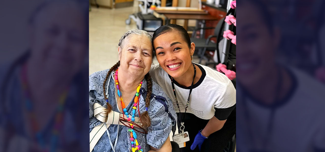 Happy patient in wheelchair with caregiver